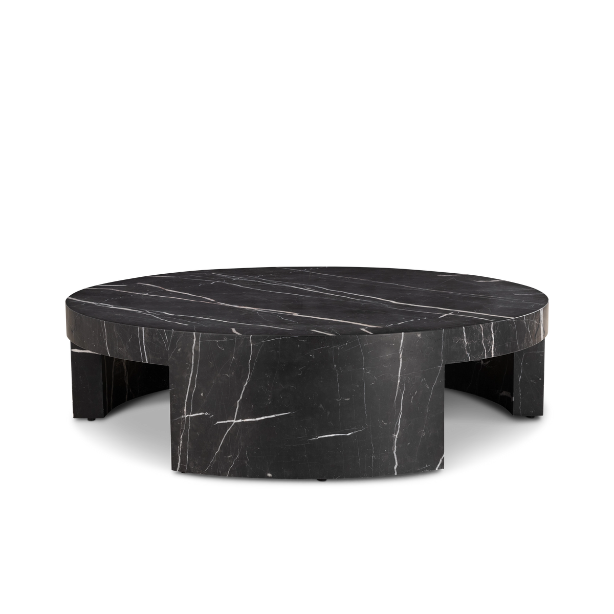 Shift Coffee Table in Black Nero Marquina marble, angled view showing the curved leg faces and the shadow beneath the low round top.