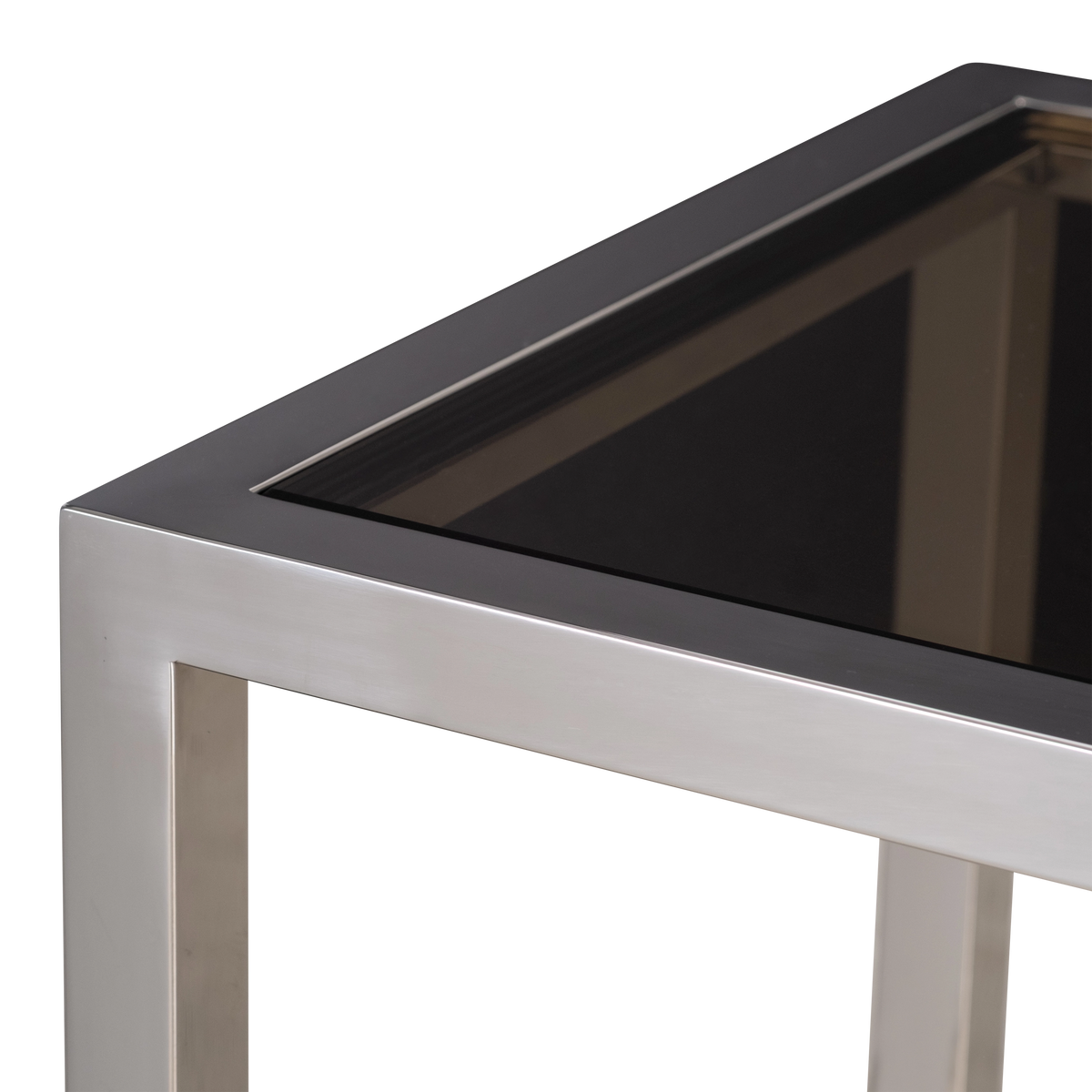 Close-up showing the top corner of the Sandro Console Table in Polished Steel, with the squared frame, the inset smoked glass, and the shelf reflected beneath.