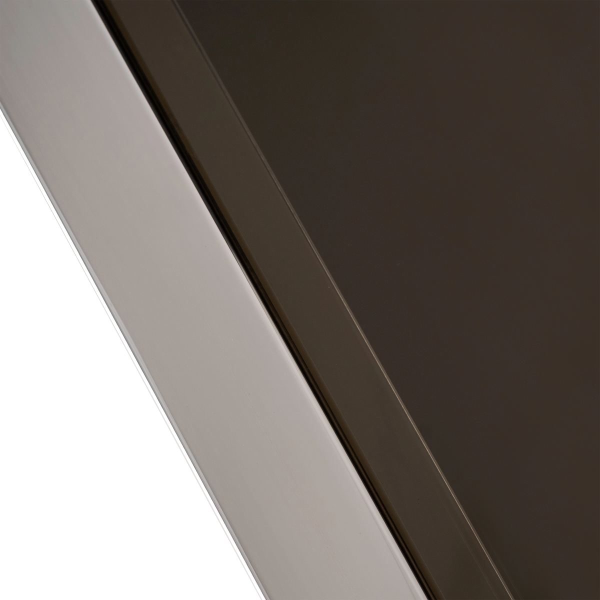 Close-up of the top edge of the Sandro Console Table in Polished Steel, showing the smooth steel rail beside the smoked glass with its bronze tint.
