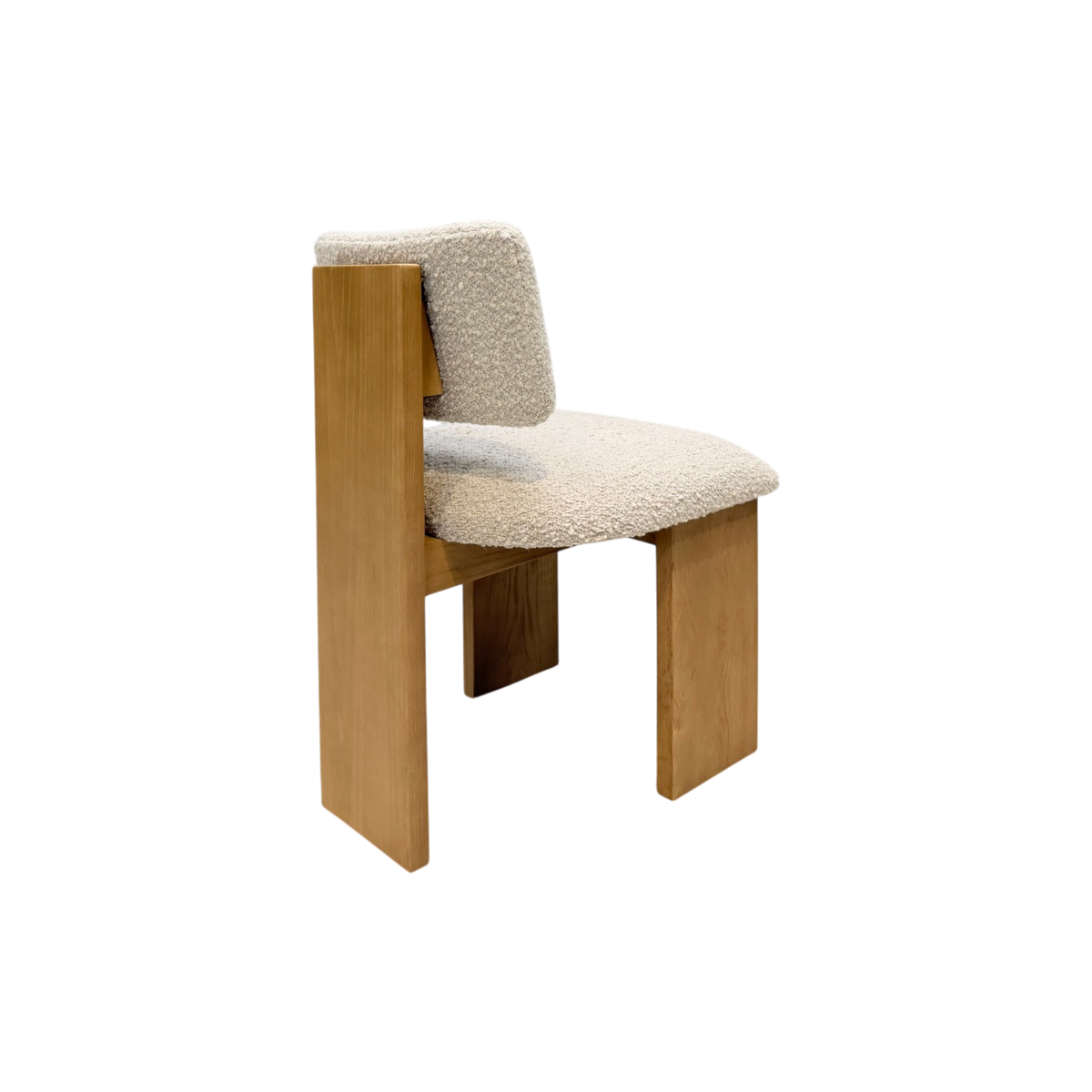A modern wooden chair with a textured cream bouclé seat and backrest, shown against a plain white background.