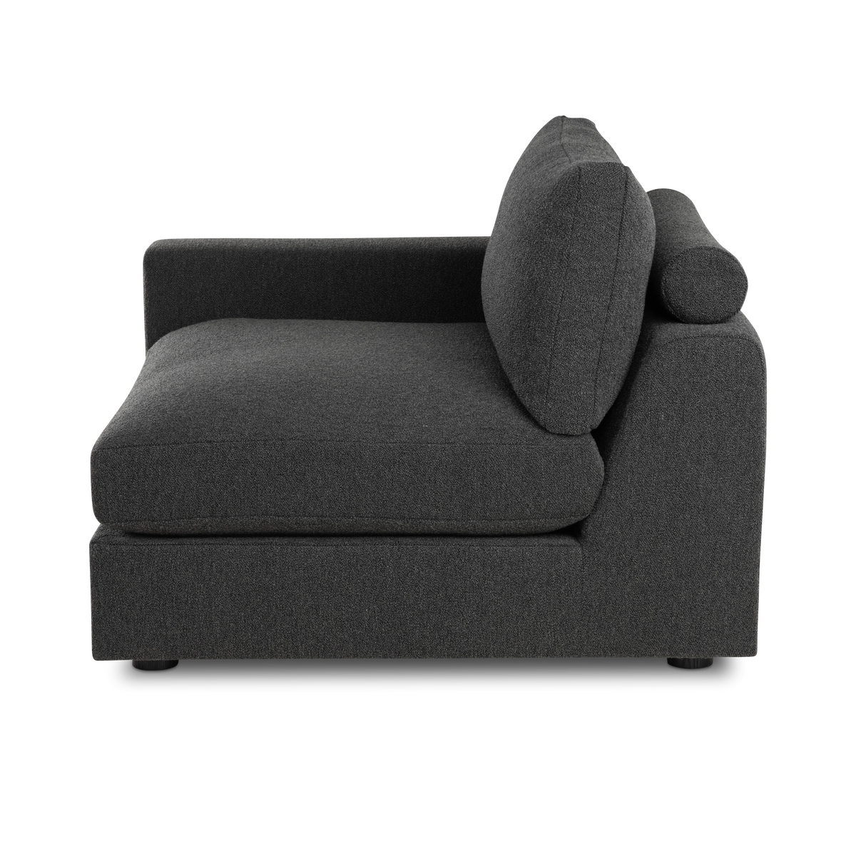 Side profile of the Colonna Modular LAF Chair in charcoal bouclé, showing the slim cylindrical bolster, the angled back cushion with its stitched edge, and the tall low-set arm.