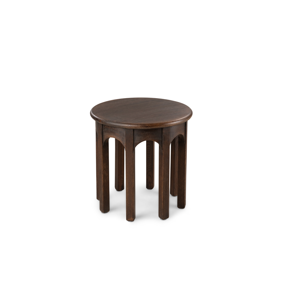 Calloway Side Table angled slightly from above in dark brown elm, showing the smooth round top, arched apron detail, and evenly spaced legs.