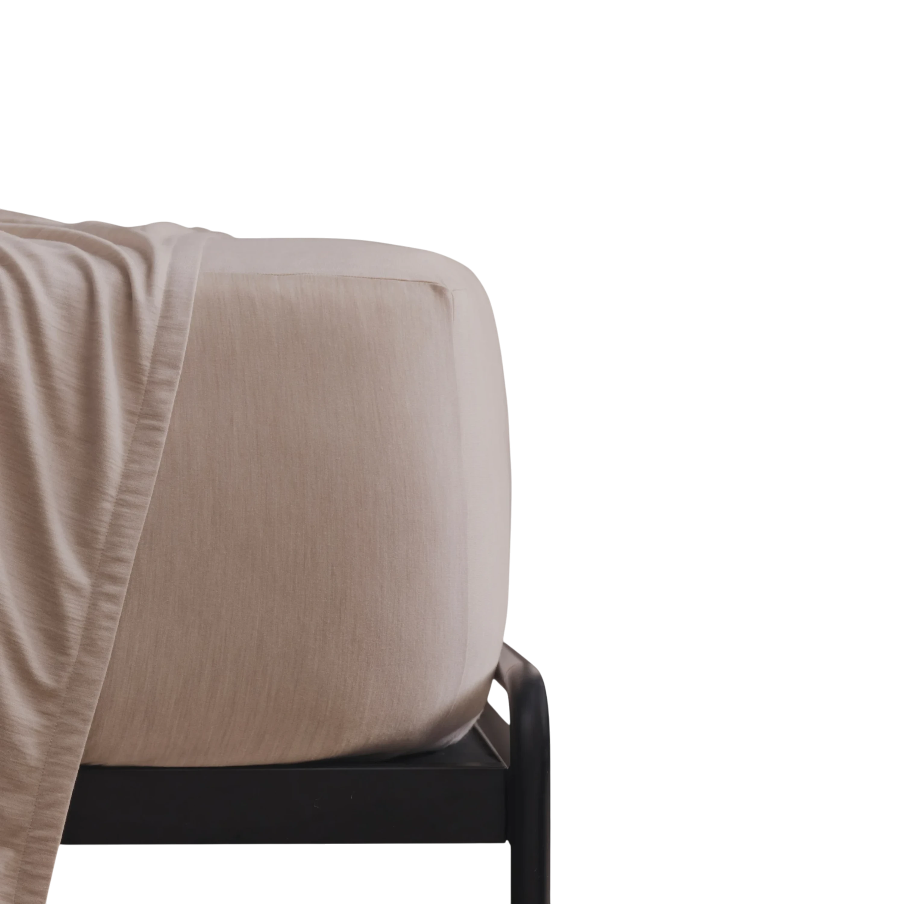 Merino Fit Sheet King in Sand Merino Jersey shown fitted over a mattress with coordinating bedding draped over the edge.