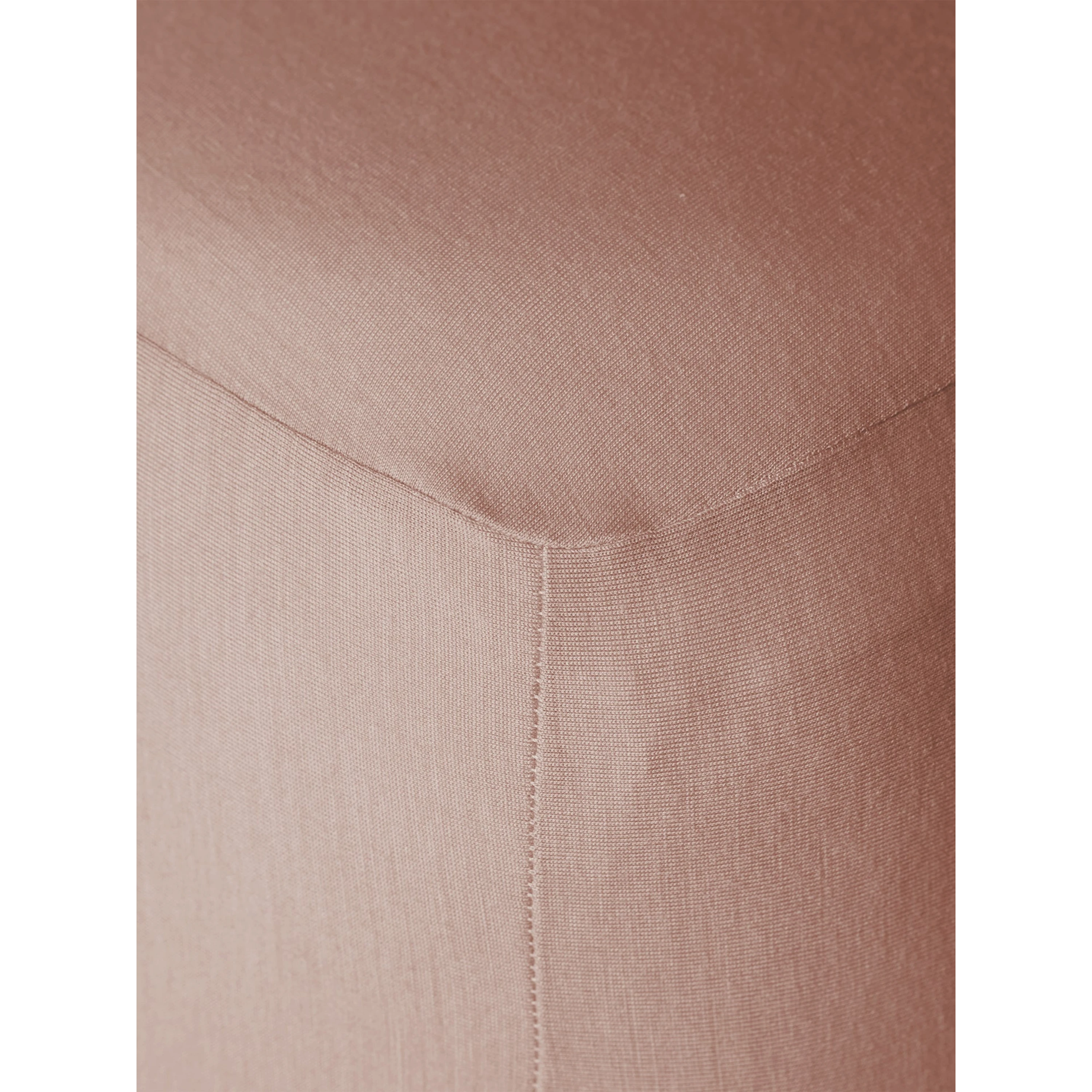 Close-up of Merino Fit Sheet King in Rose showing the smooth jersey texture, fitted corner and tailored seam detail.