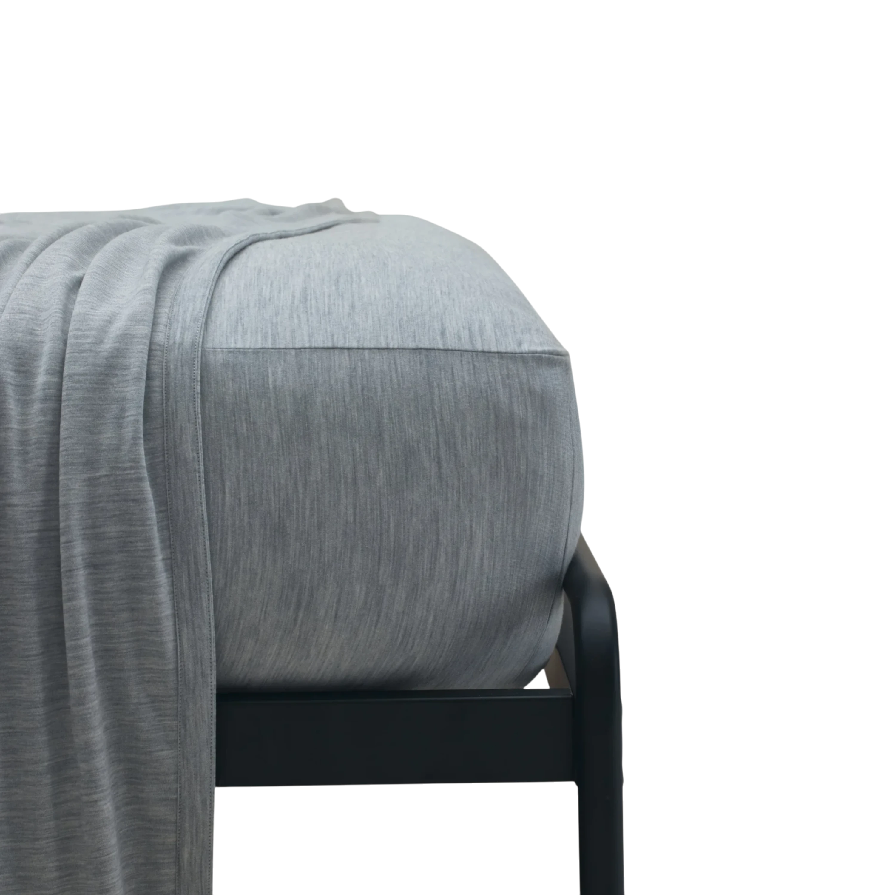 Merino Fit Sheet Queen in Granite grey Merino Jersey shown fitted over a mattress with coordinating bedding draped over the edge.
