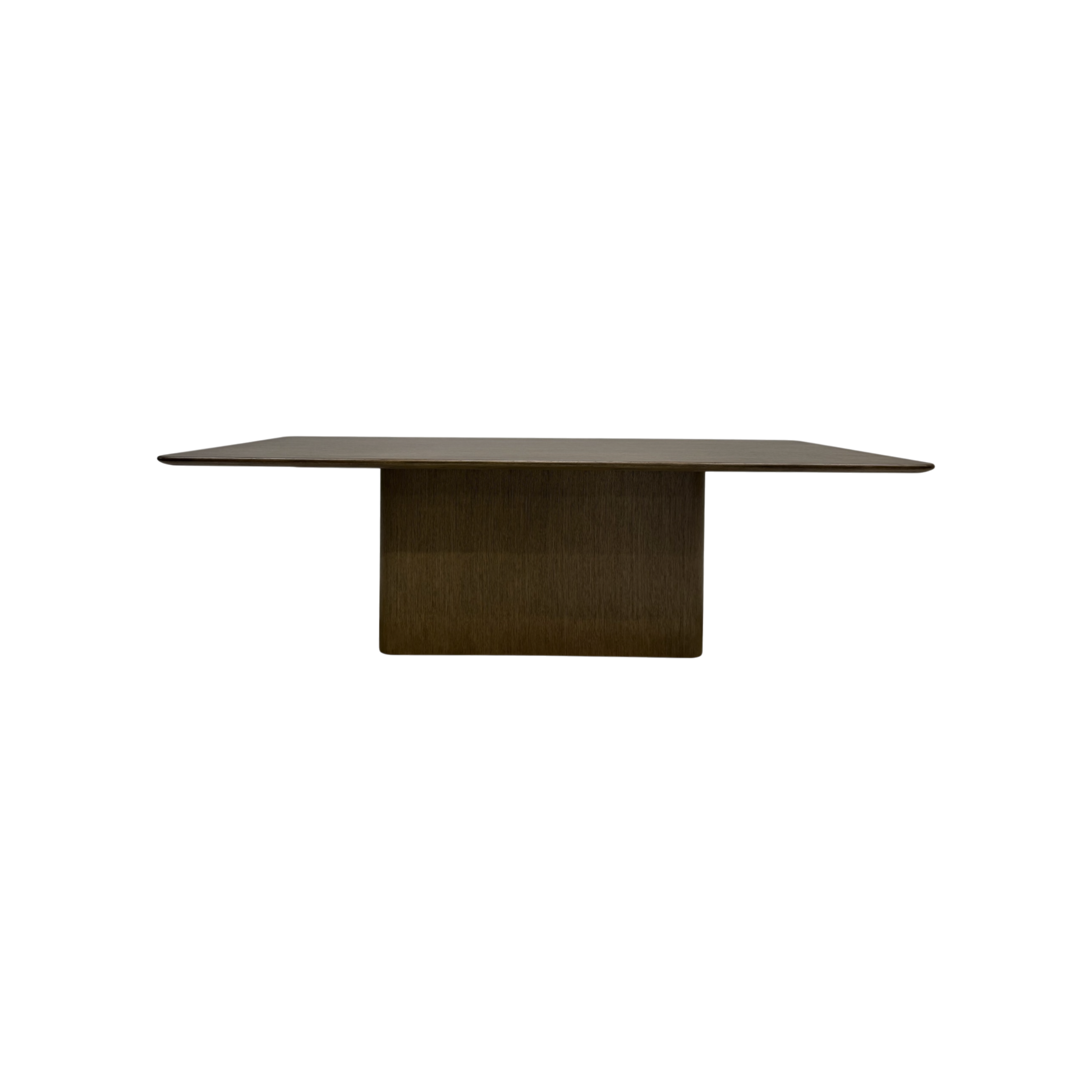 Altar Dining Table in dark wood with a long rectangular top, softly rounded edges and a substantial central pedestal base.