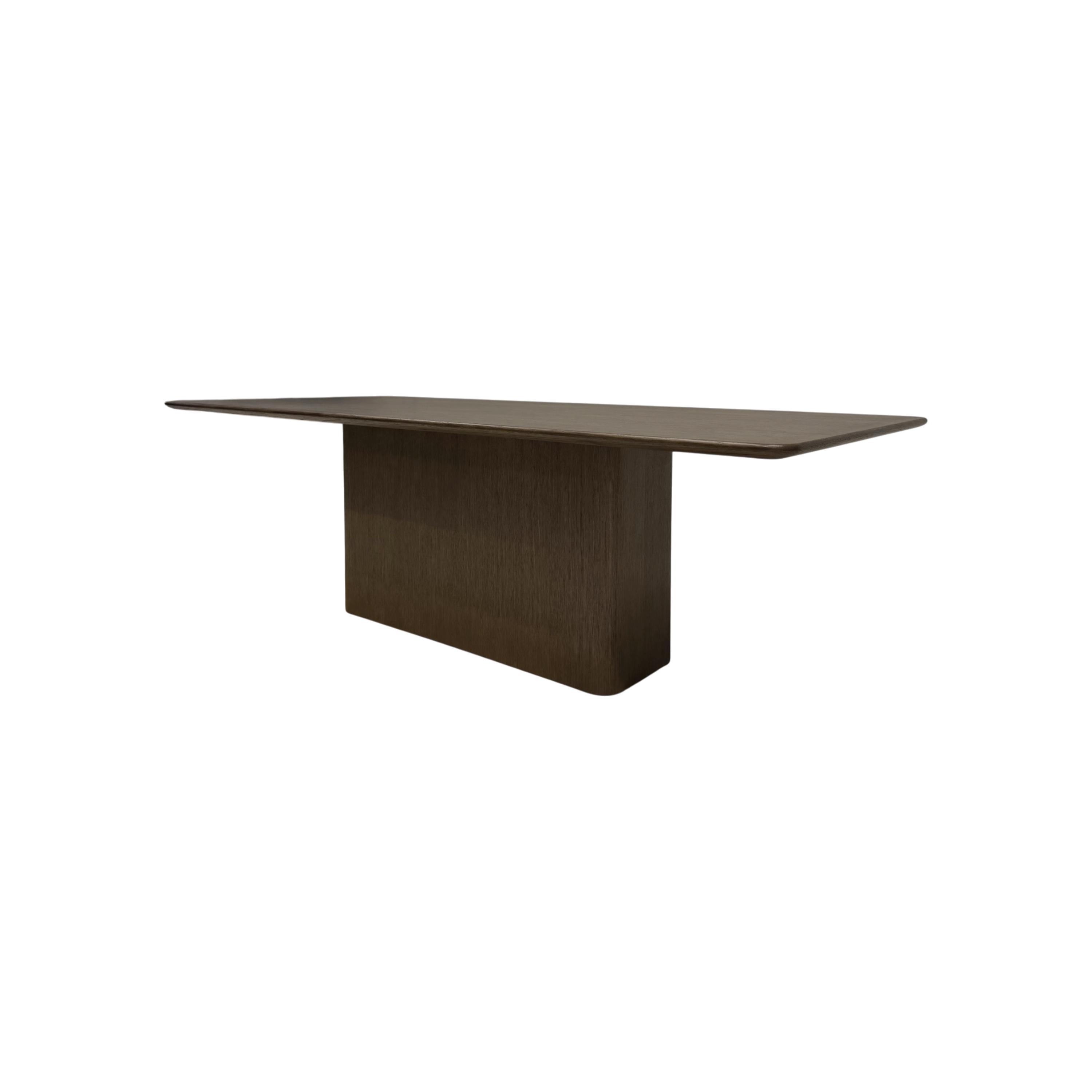 Angled view of the Altar Dining Table showing its elongated wood top, gently softened corners and architectural pedestal base.