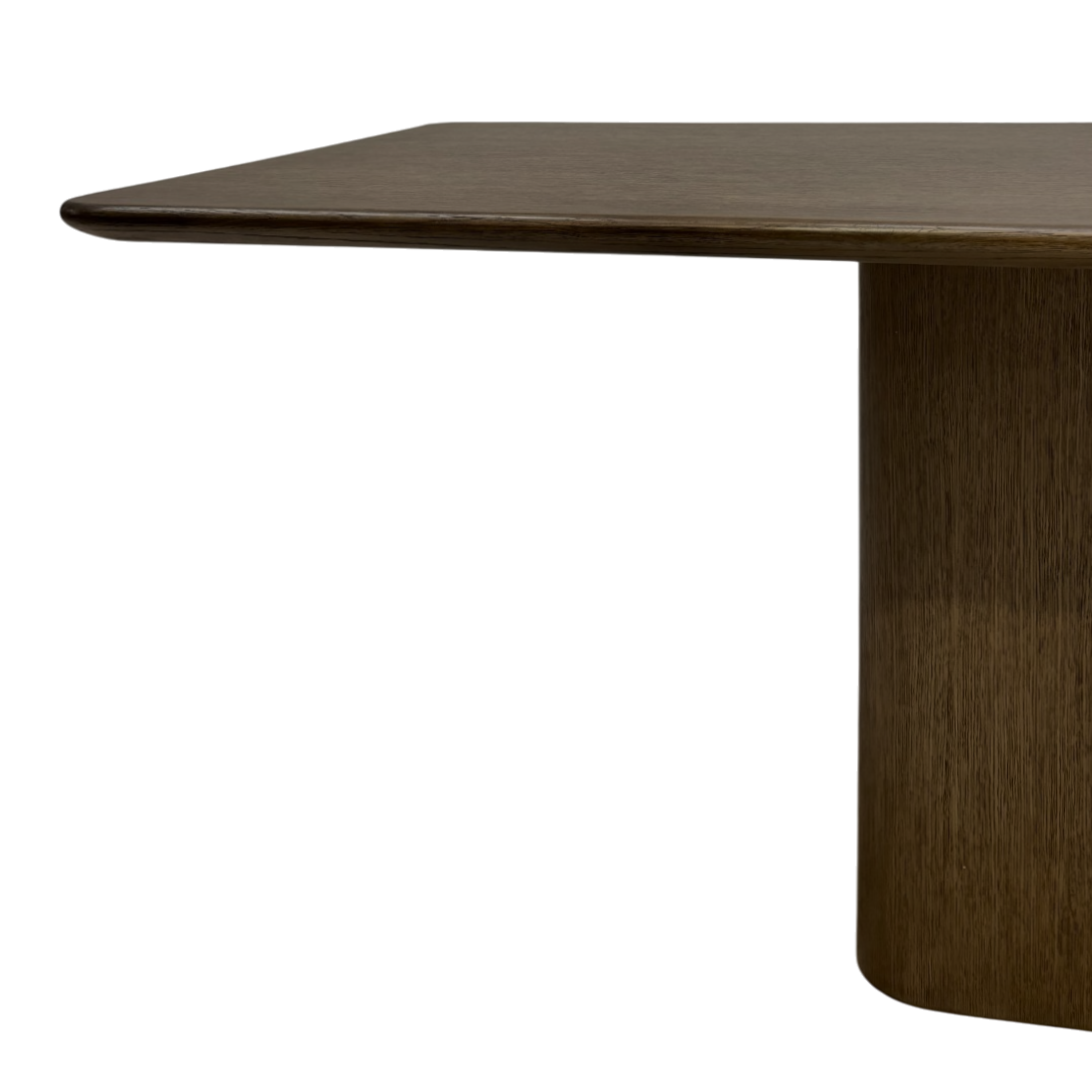 Close-up of the Altar Dining Table showing the dark wood tabletop with softly rounded edge and substantial central pedestal base.
