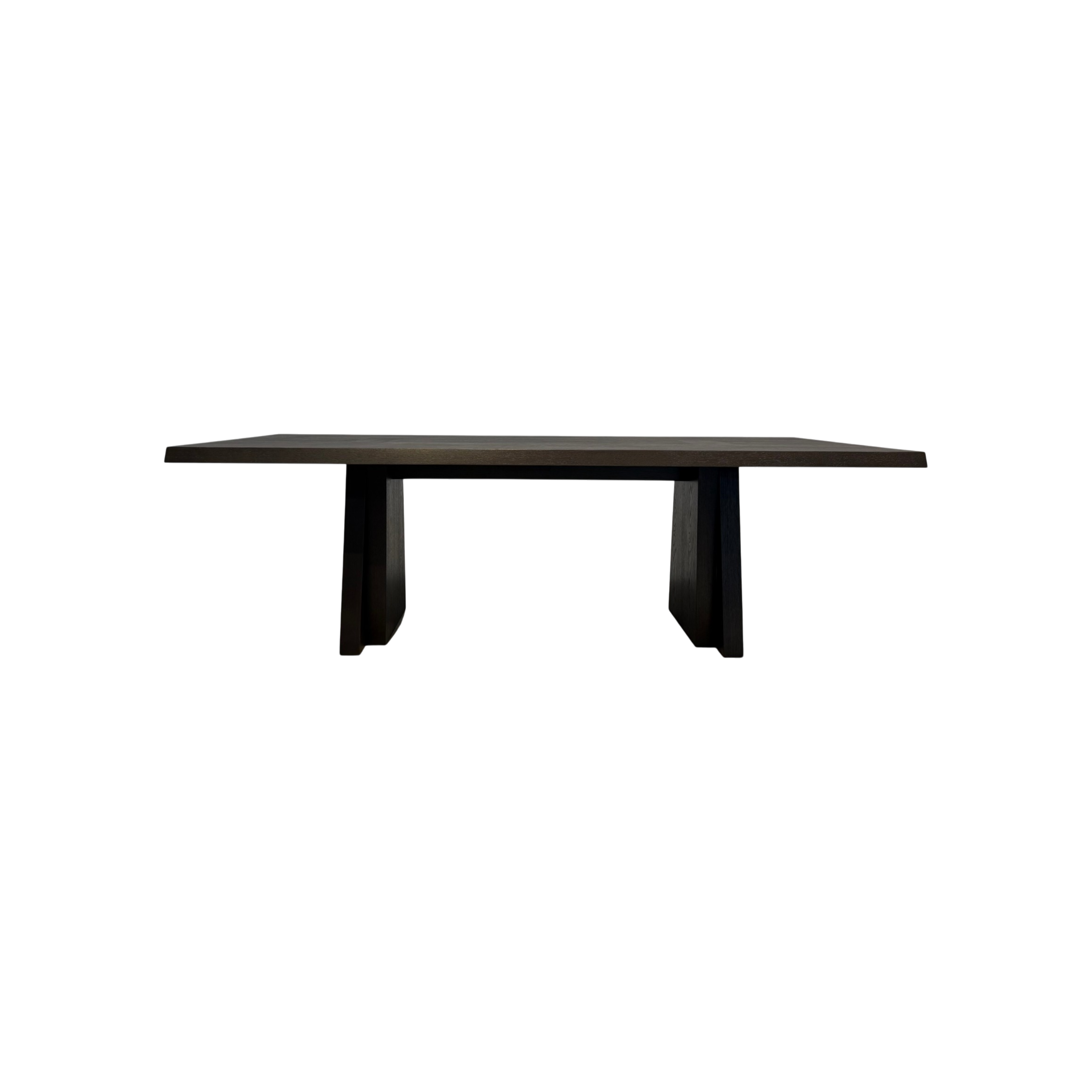 Oblique Dining Table in dark wood with a long rectangular top and two angular trapezoidal pedestal bases.