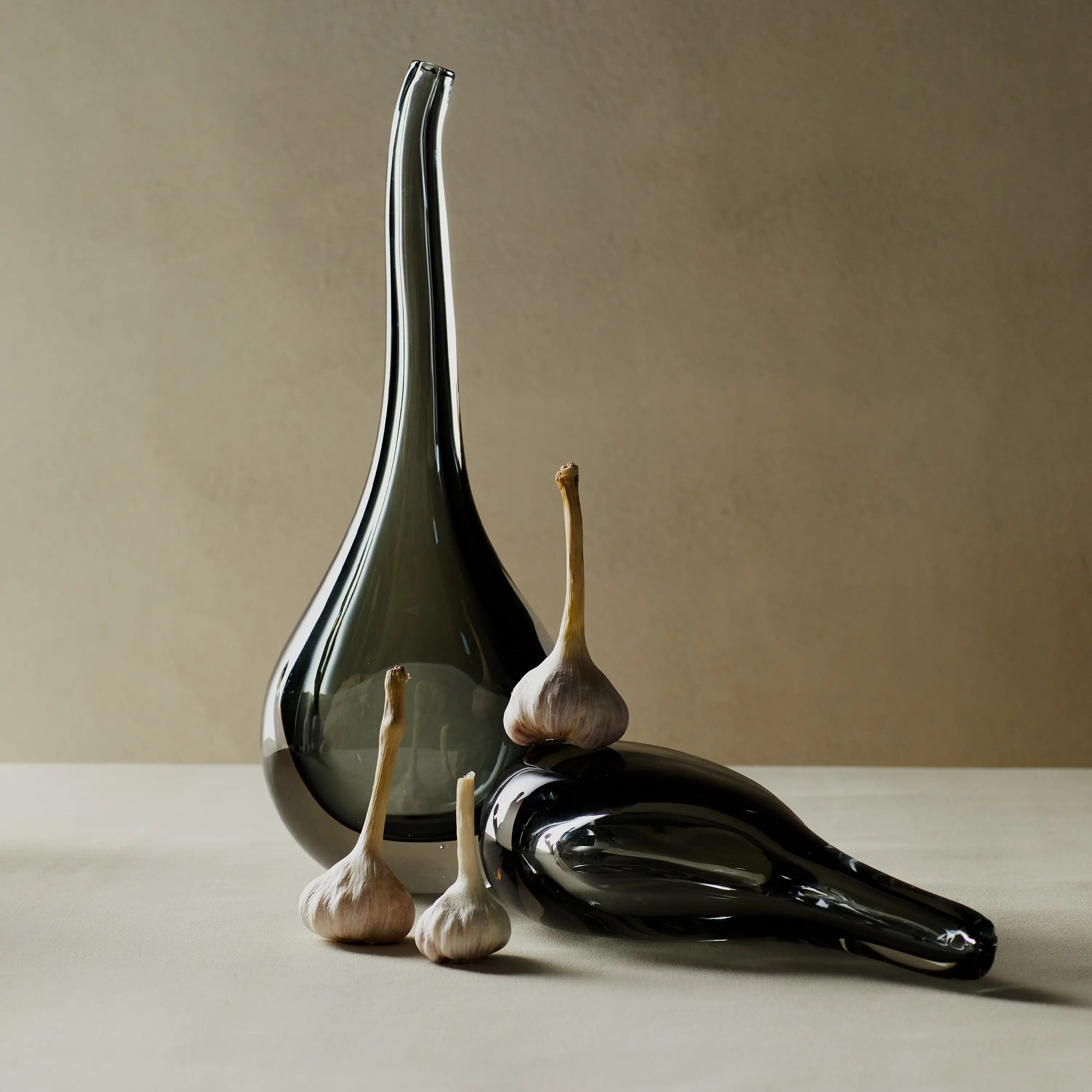 Reminiscent of a raindrop, the Stretched Neck Vase has an elegant round silhouette with a tall, long neck.