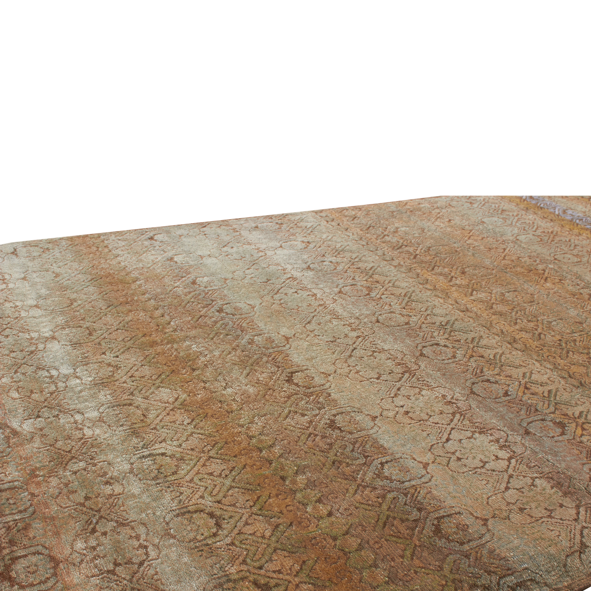 A close-up of a patterned rug with an intricate geometric and floral design in muted earthy tones of brown, beige, and gray, shown against a solid white background.