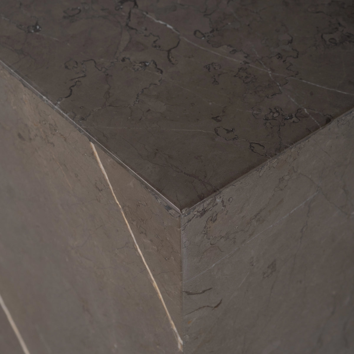 Duvall Console Table shown from the front in warm gray Petra Grey marble, with a long slab top spanning two solid block legs.