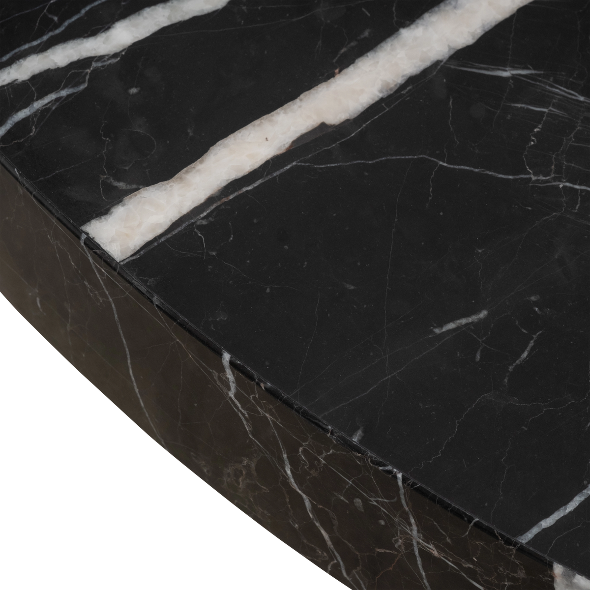 Close-up of the honed top of the Shift Coffee Table in Black Nero Marquina marble, highlighting wide cream-white veins and the clean rim along the curve.