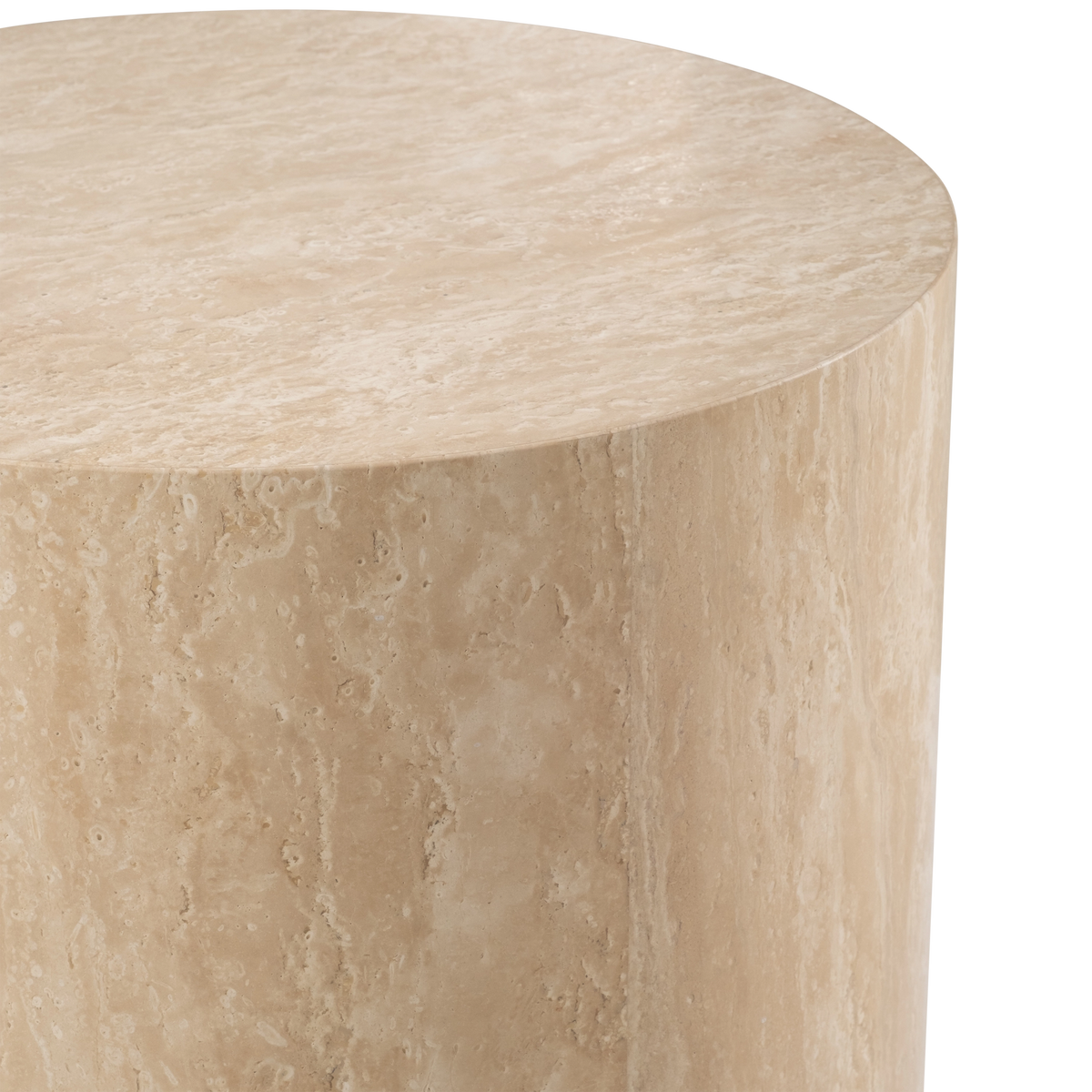 Close-up showing the top edge of the Meta Round Side Table in Warm Beige travertine, with the honed surface, fine pitting, and fibrous veining along the curved side.