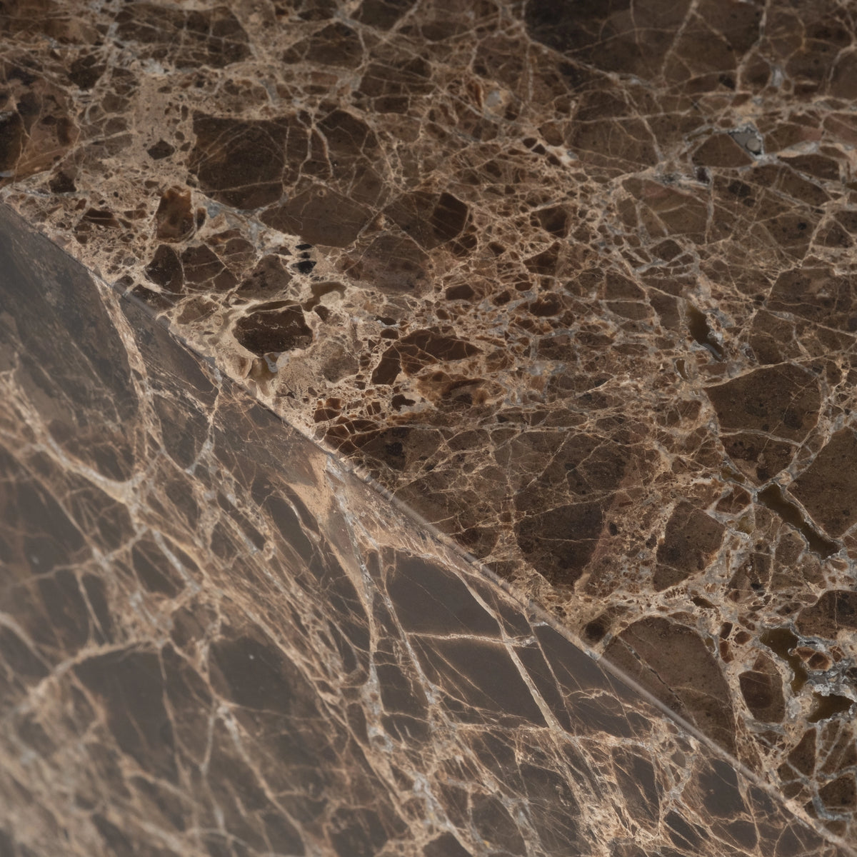 Close-up of the top edge of the Meta Square Side Table in Chocolate Brown Dark Emperador marble, highlighting the honed finish and the warm tan breccia veining.