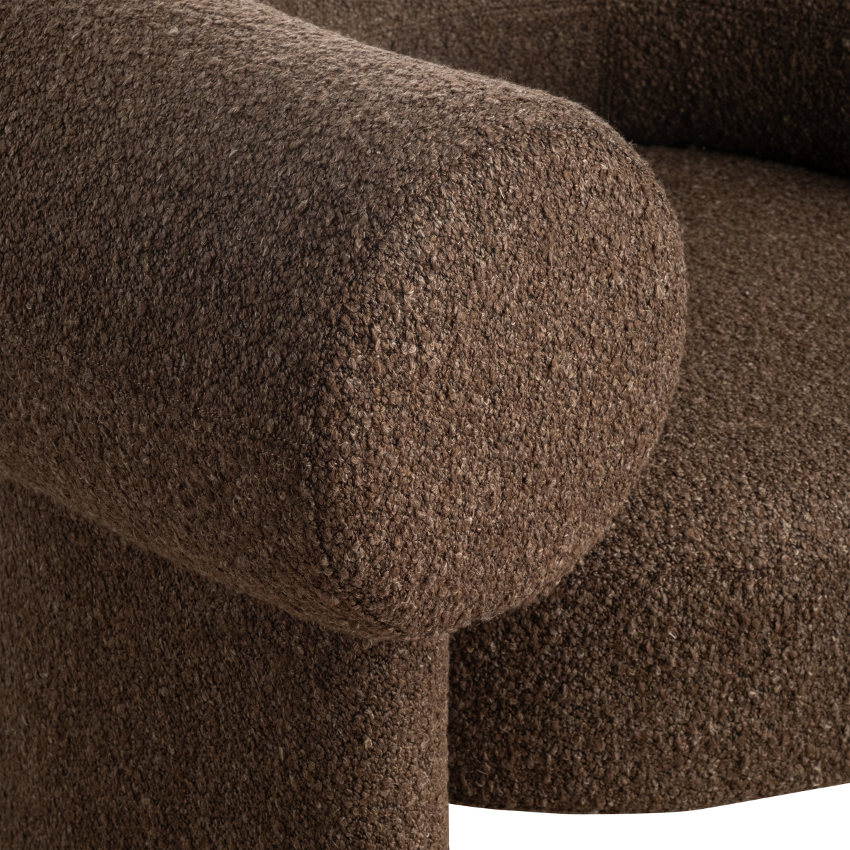 Close-up showing the arm and seat of the Embrace Lounge Chair in Espresso bouclé, with fine looped texture and a clean seam where the arm meets the base.