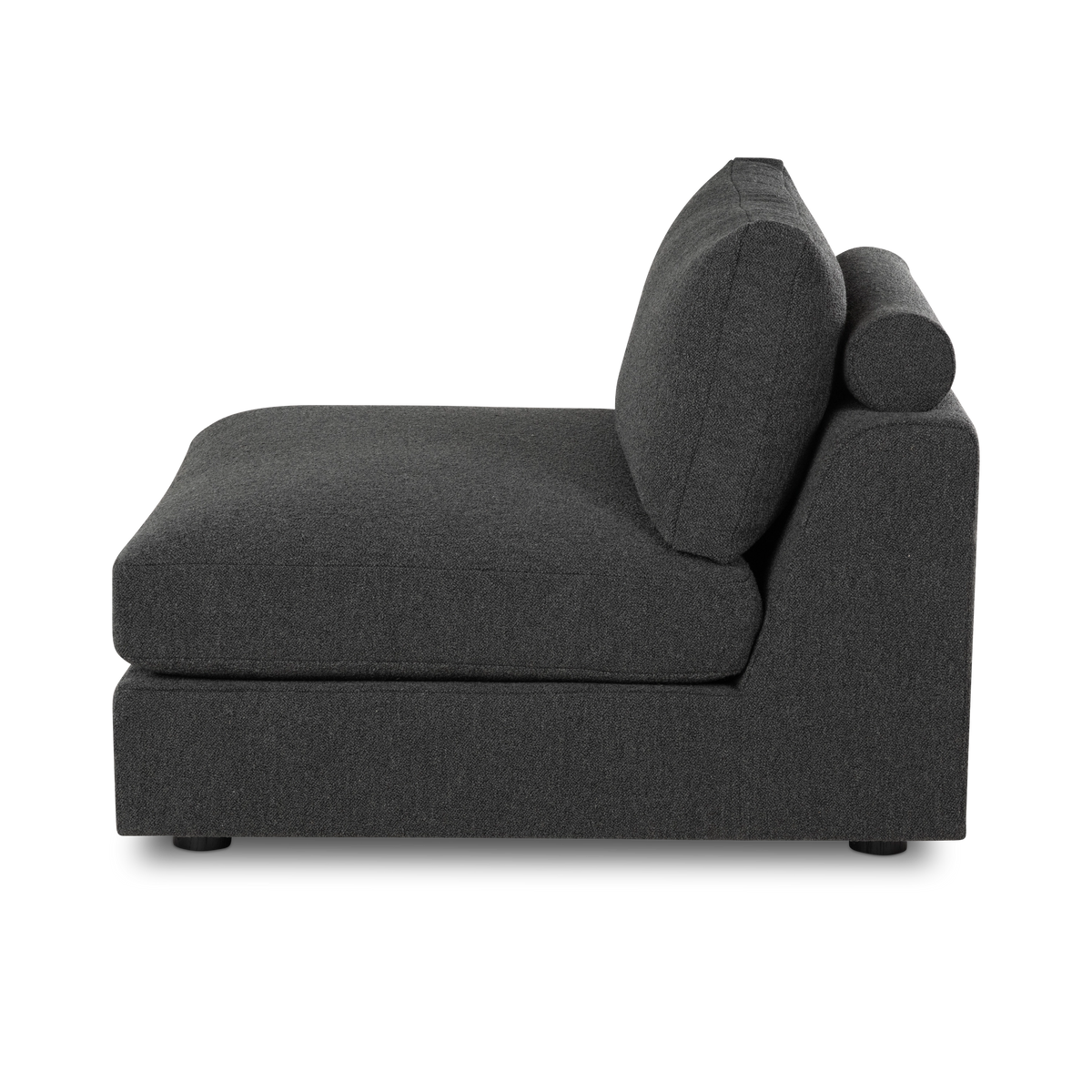 Side profile of the Colonna Modular Armless Chair in charcoal bouclé, showing the slim cylindrical bolster, the angled back cushion with its stitched edge, and the low-set side panel.