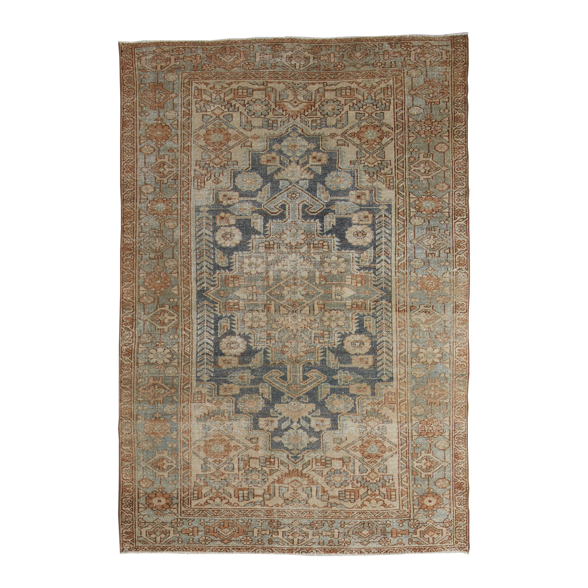 A rectangular vintage-style area rug with an intricate traditional pattern in muted blue, beige, rust orange, and gray tones, shown flat against a plain white background.