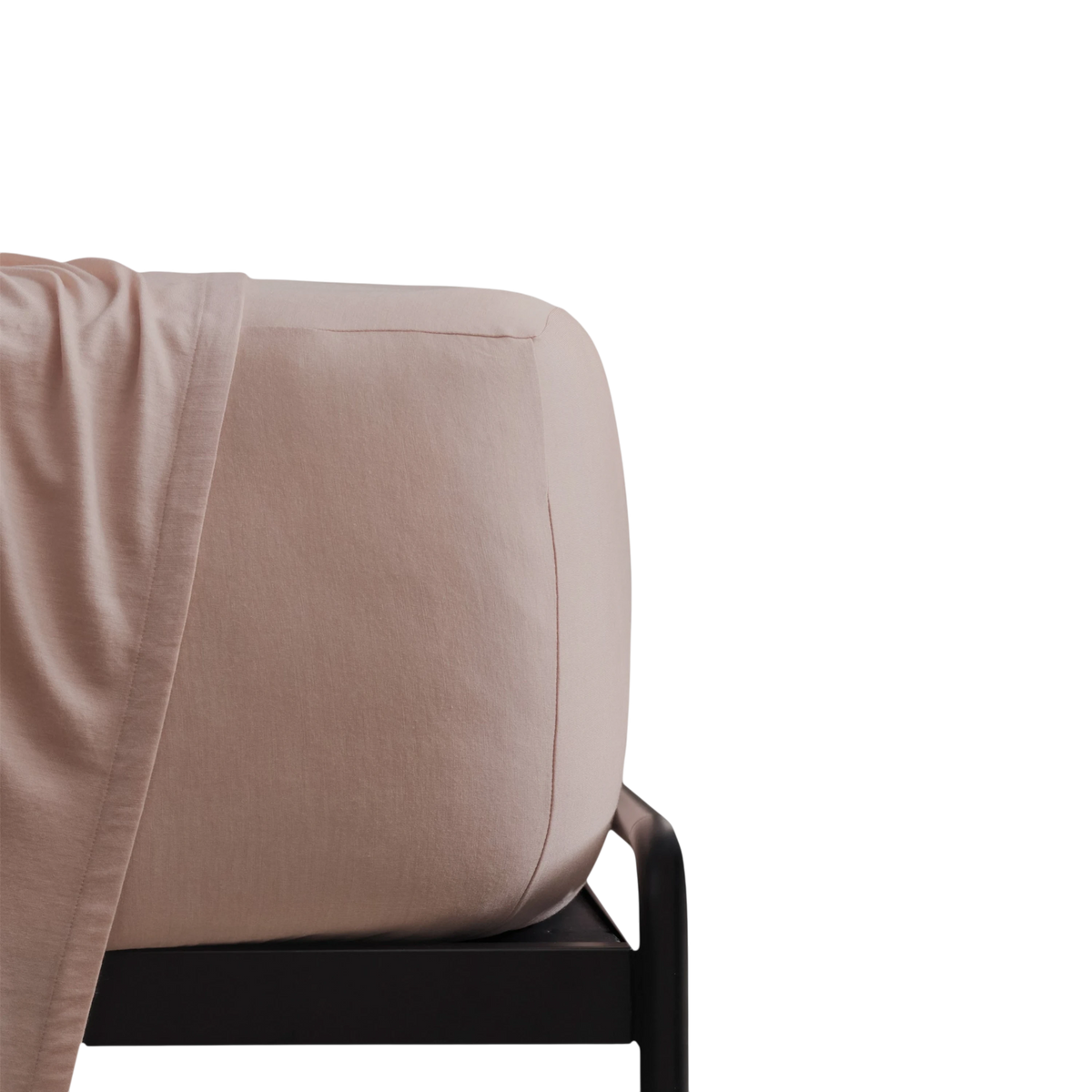 Merino Fit Sheet King in Rose Merino Jersey shown fitted over a mattress with coordinating bedding draped over the edge.