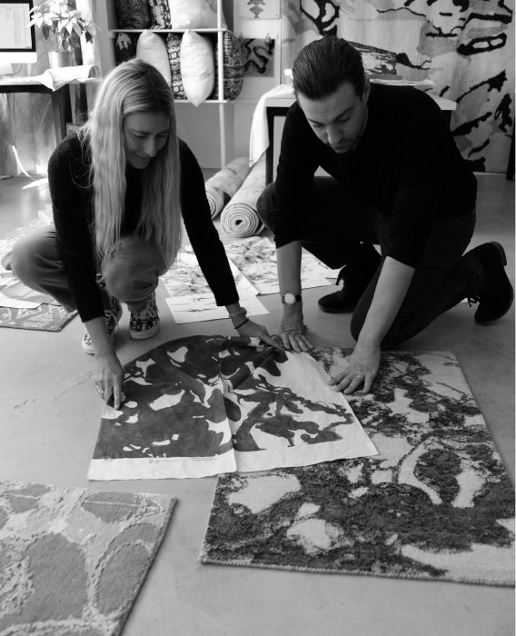 Two designers examine samples on the floor