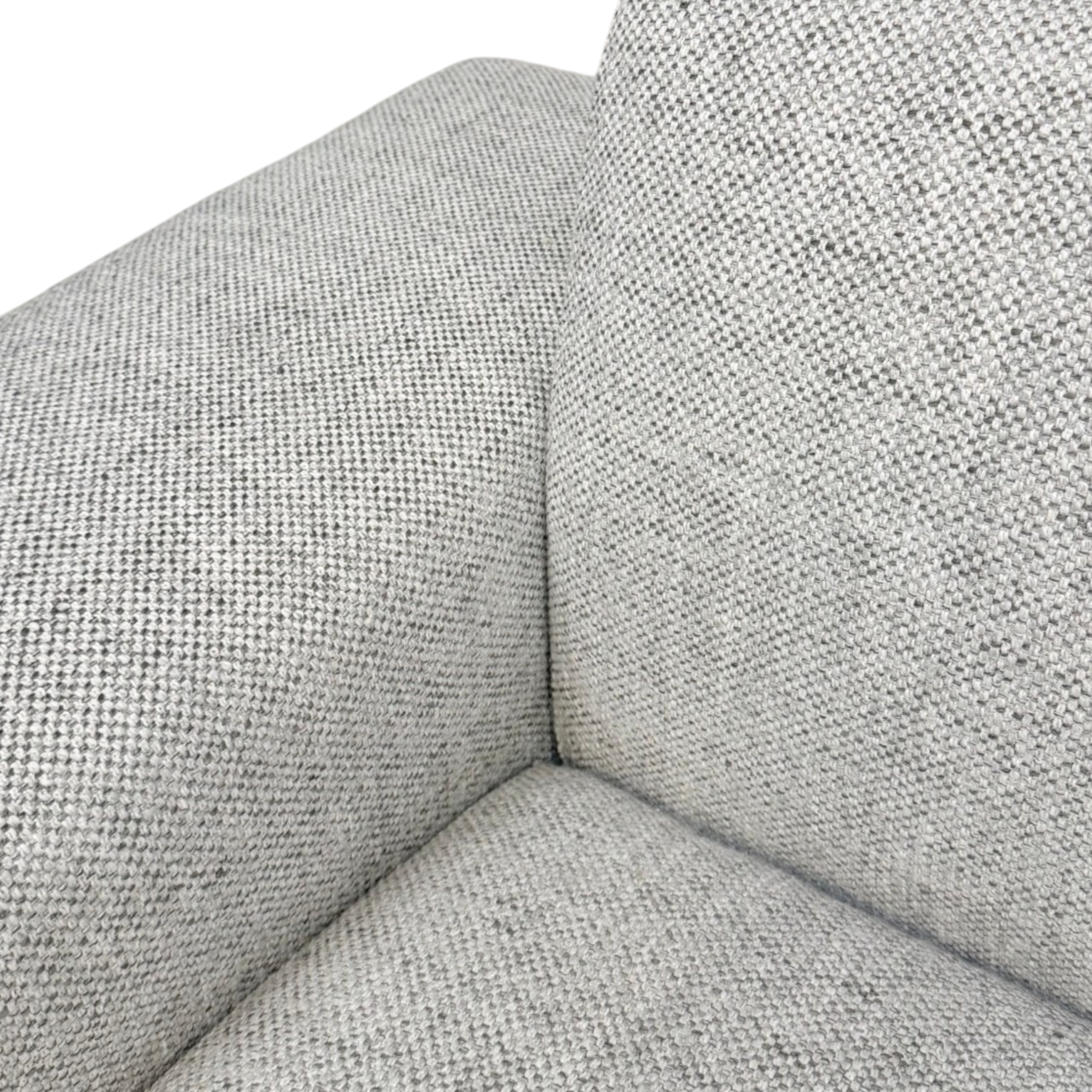 Close-up of Vetro Bullnose Sectional light woven grey upholstery at the seat, back and arm junction.