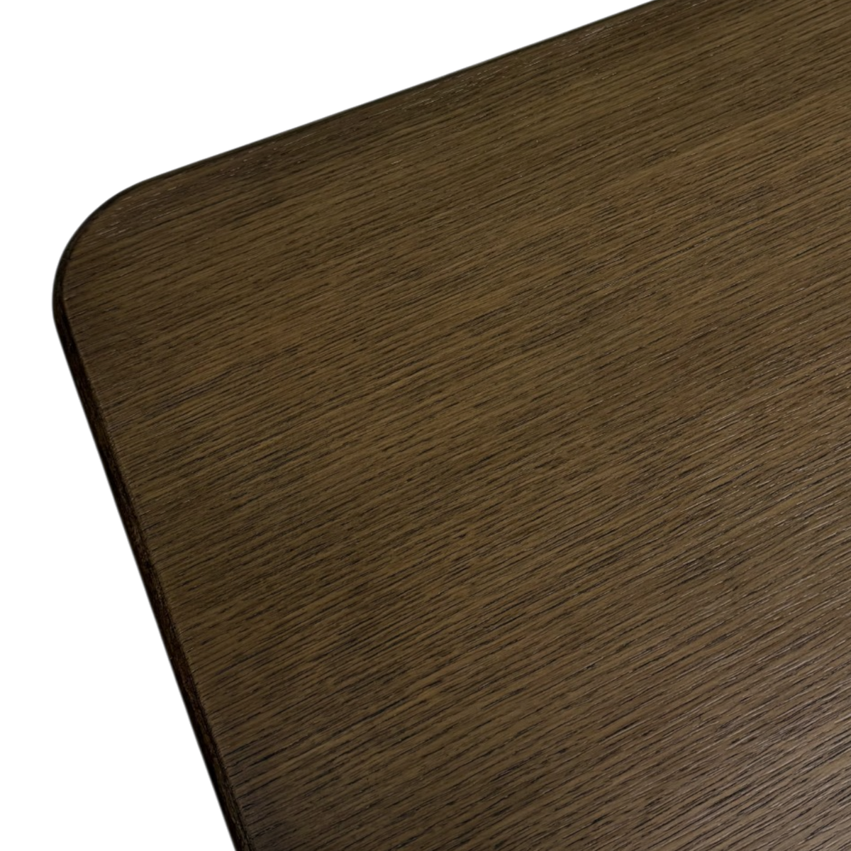 Detail view of the Altar Dining Table highlighting the rich dark wood grain, smooth finish and gently rounded tabletop corner.