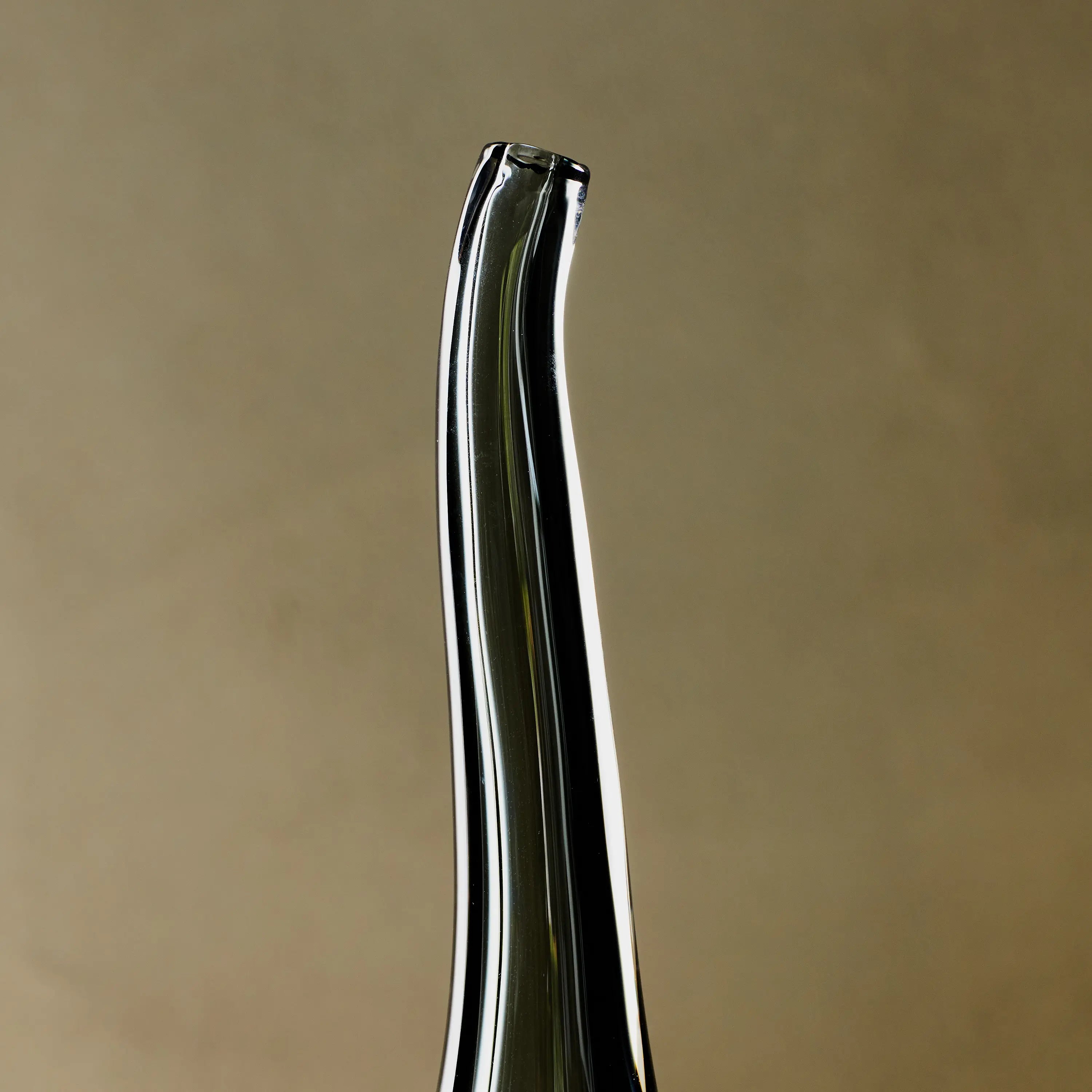 Reminiscent of a raindrop, the Stretched Neck Vase has an elegant round silhouette with a tall, long neck.