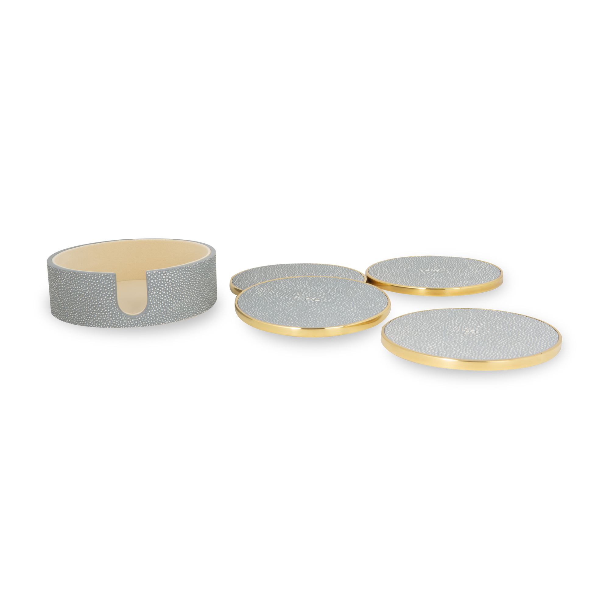 Luxurious coaster set wrapped in faux shagreen with brass accents and velvet backing.