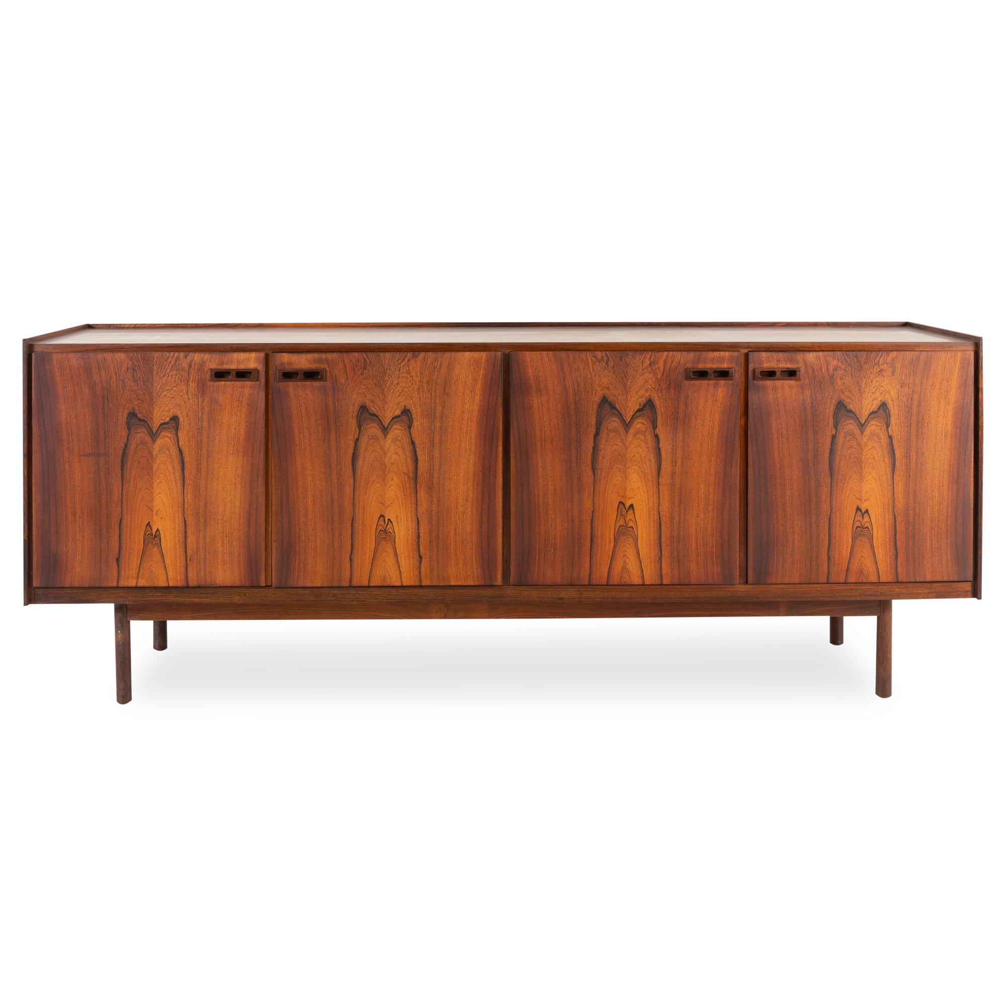 Displaying elegantly aged rosewood, this vintage sideboard was designed by Ib Kofod-Larsen and produced by Brande Mobelfabrik, circa 1960s.
