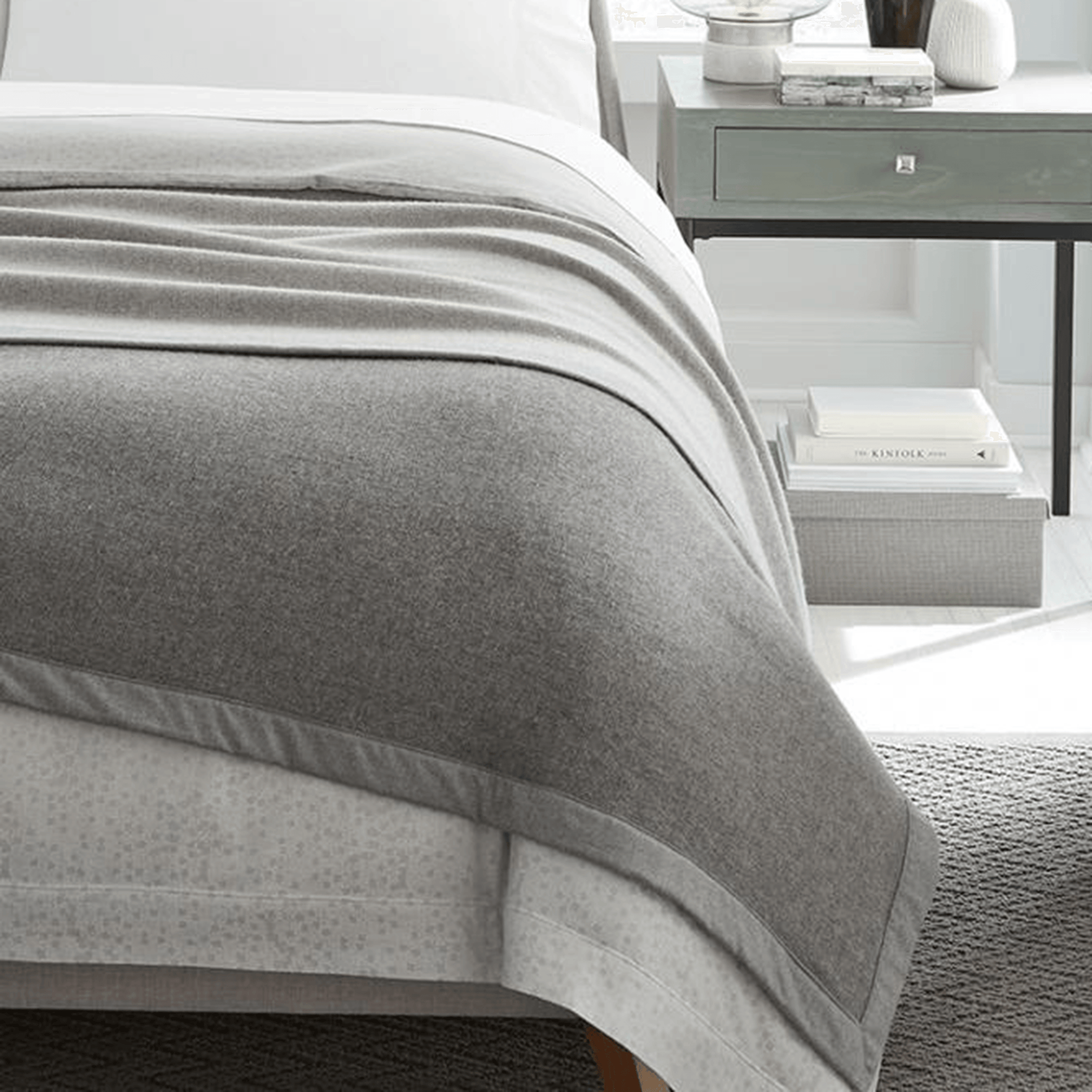 Woven in super-fine Merino wool, the Nerino blanket adds superior warmth and is reversible with differing front and back hues - grey and light grey.